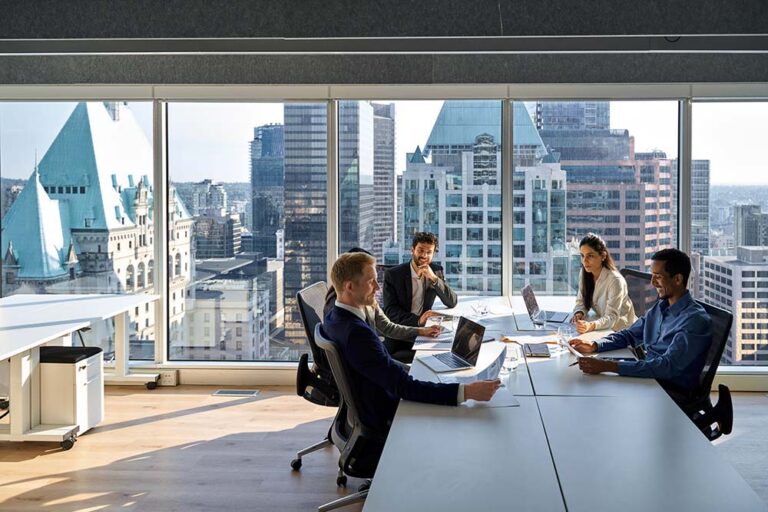 Group of business people in an office with skyscrapers in the background