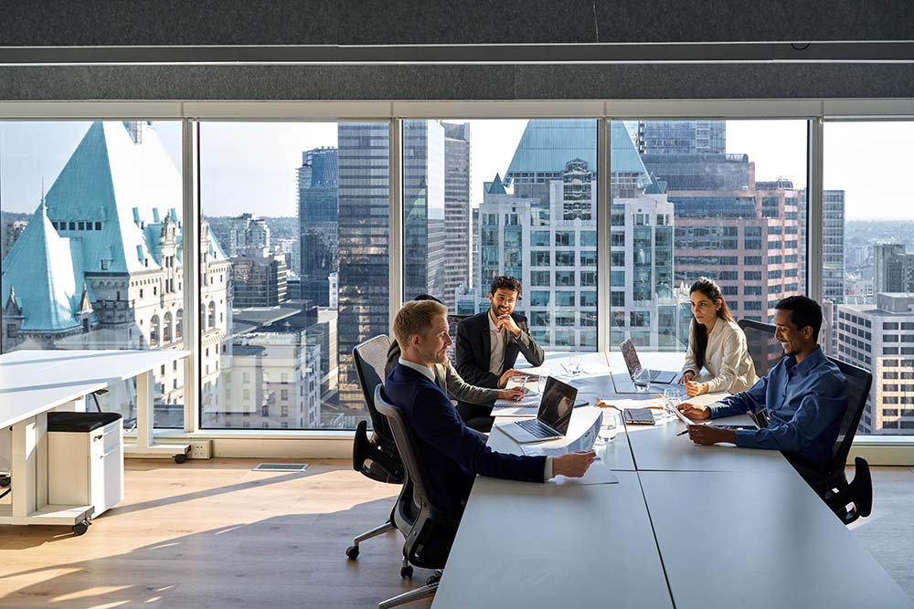 Group of business people in an office with skyscrapers in the background