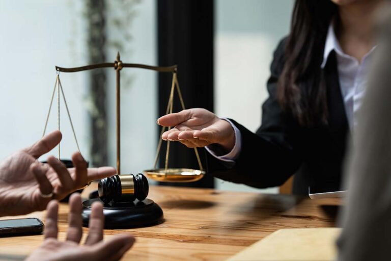 Jurisprudence - a desk with two people arguing and items that suggest it is a law office